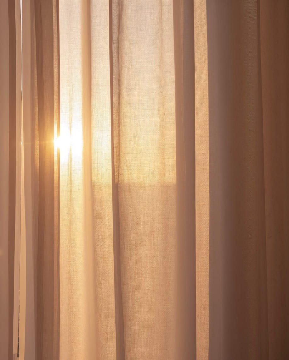 Late daylight coming through a linen curtain.